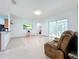 Living room area with tile flooring, a ceiling fan, and access to the outside patio at 3731 Peaceful Valley Dr, Clermont, FL 34711