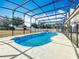 Inviting screened-in pool with a tanning ledge, perfect for cooling off and relaxing in the Florida sun at 3731 Peaceful Valley Dr, Clermont, FL 34711