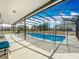 Spacious screened-in pool area with ample deck space, ideal for outdoor gatherings and poolside relaxation at 3731 Peaceful Valley Dr, Clermont, FL 34711