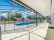 Large screened-in pool area with an extended patio, perfect for entertaining or relaxing by the water at 3731 Peaceful Valley Dr, Clermont, FL 34711