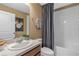 Well-lit bathroom featuring a vanity with a mirror, toilet, and a shower-tub combination with white tiles at 4102 Penelope Ave, Lake Wales, FL 33859