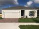 Charming single-story home featuring a two-car garage, landscaped yard and neutral color palette at 4102 Penelope Ave, Lake Wales, FL 33859