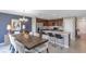 Open-concept kitchen and dining area with dark cabinetry, stainless appliances, and bar seating at 4102 Penelope Ave, Lake Wales, FL 33859