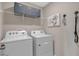 Functional laundry room with washer, dryer, shelving and storage solutions for organization at 4102 Penelope Ave, Lake Wales, FL 33859