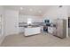 Modern kitchen with white cabinets, stainless steel appliances, black countertops and an island at 4817 Cr 686, Webster, FL 33597