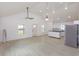 Bright open-concept living space featuring modern lighting, kitchen view and neutral decor at 4817 Cr 686, Webster, FL 33597