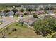 An aerial view of a home with a pool, three-car garage and a large yard at 4879 Brightmour Cir, Orlando, FL 32837