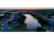 Beautiful sunset aerial of a lakeside community with mature trees, lush landscaping, and pristine waterways at 4879 Brightmour Cir, Orlando, FL 32837
