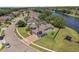 An aerial view of a home with a pool, three-car garage and water views at 4879 Brightmour Cir, Orlando, FL 32837
