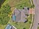 Overhead shot of a home highlighting the pool area, manicured lawn, and brick-paved driveway at 4879 Brightmour Cir, Orlando, FL 32837