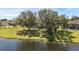 Scenic backyard view featuring mature trees and a serene pond, perfect for relaxation at 4879 Brightmour Cir, Orlando, FL 32837
