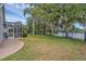 Spacious fenced backyard with mature trees, pool, landscaping, and pond views at 4879 Brightmour Cir, Orlando, FL 32837