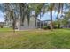 Lush backyard with mature landscaping, screened-in pool, and exterior views at 4879 Brightmour Cir, Orlando, FL 32837