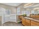 Bathroom featuring a large tub, walk-in shower, double vanity, and tile flooring at 4879 Brightmour Cir, Orlando, FL 32837