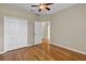 Bedroom featuring wood floors, ceiling fan, and closet storage at 4879 Brightmour Cir, Orlando, FL 32837