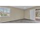 Neutral bedroom features carpet, light walls, a ceiling fan, and access to the patio area at 4879 Brightmour Cir, Orlando, FL 32837