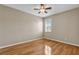 Bedroom featuring wood floors, ceiling fan, and window with plantation shutters at 4879 Brightmour Cir, Orlando, FL 32837