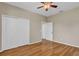 Bedroom featuring wood floors, ceiling fan, and closet storage at 4879 Brightmour Cir, Orlando, FL 32837