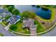 Waterfront home surrounded by lush lawns and landscaping, located on a cul-de-sac on a pristine lake at 4879 Brightmour Cir, Orlando, FL 32837