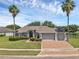 Charming home with a three-car garage, brick-paved driveway, and well-manicured lawn at 4879 Brightmour Cir, Orlando, FL 32837