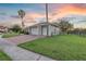 Three car garage with brick driveway and lush green lawn at 4879 Brightmour Cir, Orlando, FL 32837