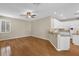 Open-concept living room and kitchen area with hardwood floors and neutral color palette at 4879 Brightmour Cir, Orlando, FL 32837