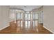 Bright living room boasts hardwood floors, white plantation shutters, and elegant chandelier at 4879 Brightmour Cir, Orlando, FL 32837