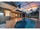 Screened-in pool with tiled deck, outdoor seating and an open-air bar at 4879 Brightmour Cir, Orlando, FL 32837
