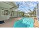 Relaxing screened pool with a large patio, ceiling fans, and beautiful backyard views at 4879 Brightmour Cir, Orlando, FL 32837