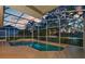 Screened-in pool with stone accents, lush tropical landscaping and sunset views at 4879 Brightmour Cir, Orlando, FL 32837
