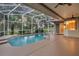 Enclosed pool area with covered patio, ceiling fans, and access to backyard at 4879 Brightmour Cir, Orlando, FL 32837