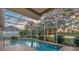 Screened pool with patio area offering lake views and mature landscaping at 4879 Brightmour Cir, Orlando, FL 32837