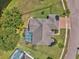 Overhead shot of a home highlighting the pool area, manicured lawn, and brick-paved driveway at 4879 Brightmour Cir, Orlando, FL 32837