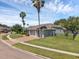 Rear view of a single-story home featuring a 3-car garage, fenced yard, and lush lawn at 4879 Brightmour Cir, Orlando, FL 32837