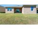 Home's back exterior showing the sliding glass door and windows at 4998 Abigail Dr, Lake Wales, FL 33859
