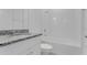 Bathroom featuring a granite countertop vanity, white cabinets, toilet, and a tiled bathtub with shower at 4998 Abigail Dr, Lake Wales, FL 33859