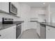 Stylish kitchen featuring granite countertops, stainless steel appliances, and white cabinets with modern fixtures at 4998 Abigail Dr, Lake Wales, FL 33859