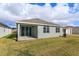 Backyard features a patio and windows overlooking a well-maintained lawn at 5006 Abigail Dr, Lake Wales, FL 33859