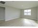 Spacious bedroom with neutral walls, light wood-look flooring, and a bright window at 5006 Abigail Dr, Lake Wales, FL 33859