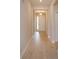 Inviting hallway with light wood-look flooring leading to the front door with sidelights at 5006 Abigail Dr, Lake Wales, FL 33859