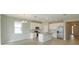 Spacious kitchen with white cabinets, stainless steel appliances, island and view to the entry way at 5006 Abigail Dr, Lake Wales, FL 33859