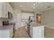 Open kitchen featuring white cabinets, stainless appliances, kitchen island, and modern finishes at 5006 Abigail Dr, Lake Wales, FL 33859