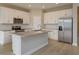 Bright kitchen with white cabinets, stainless steel appliances, kitchen island, and modern finishes at 5006 Abigail Dr, Lake Wales, FL 33859