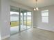 Bright living area featuring sliding glass doors and a window overlooking the backyard at 5006 Abigail Dr, Lake Wales, FL 33859