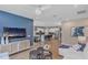Open-concept living room flowing into a kitchen with stylish blue accent wall and modern decor at 524 Silver Palm Dr, Haines City, FL 33844