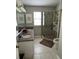 Well-lit bathroom featuring a dual sink vanity and a step-in shower with glass door at 529 Del Mar Dr, Lady Lake, FL 32159