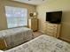 Bedroom with two twin beds, bright window and dressers at 529 Del Mar Dr, Lady Lake, FL 32159