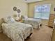 Comfortable bedroom with two twin beds and natural light at 529 Del Mar Dr, Lady Lake, FL 32159