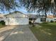 Charming single-story home featuring a two-car garage and well-maintained front yard at 529 Del Mar Dr, Lady Lake, FL 32159