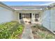 Cozy front porch seating area with charming decor and manicured landscaping at 529 Del Mar Dr, Lady Lake, FL 32159